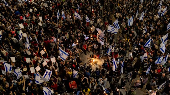 Protesters light a fire during a demonstration calling for a hostages deal and against the Israeli government, Tel Aviv.