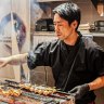 Chef Naoyuki Suzuki on the grill in the Yakitori Washokudo kitchen.