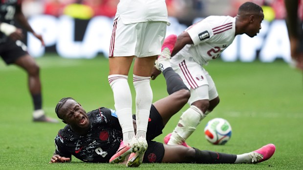 Ismael Kone's leg is broken after a tackle from Assim Madibo of Qatar.