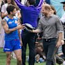 Tom Liberatore teaches Harry about Australian rules football.