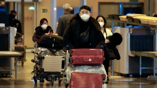 Passengers coming with an Air China flight from Guangzhou, China, leave a COVID-19 testing area set at Rome’s Leonardo da Vinci international airport in Fiumicino, on Thursday.