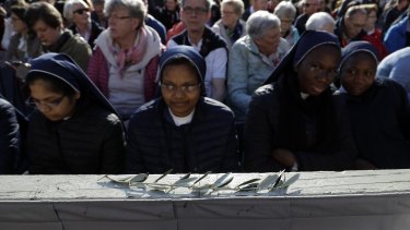 Nuns take part in the Palm Sunday Mass   in St Peter's Square at the Vatican.