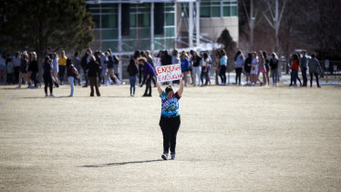 Leah Zundel holds a sign as she and other students from Columbine High participate in a walkout to honour victims of gun violence in March 2018.