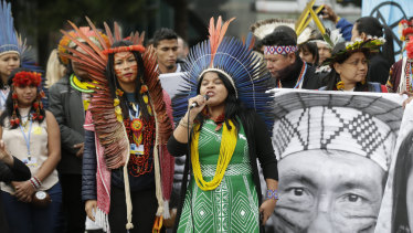 Brazilian indigenous leader Sonia Guajajara speaks alongside other activists in a protest outside the COP25 Climate summit in Madrid, Spain.