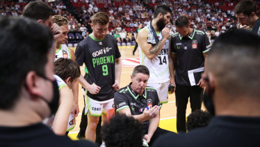 Phoenix coach Simon Mitchell speaks to his players in a timeout during the round three NBL game between the Sydney Kings and South East Melbourne Phoenix at Qudos Bank Arena.