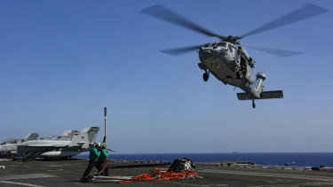 A Sea Hawk helicopter prepares to take a load on the flight deck of aircraft carrier USS Abraham Lincoln in the Persian Gulf on Friday.