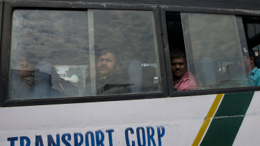 Indian pilgrims sit inside a government bus as they prepare to leave Srinagar, Indian controlled Kashmir.