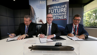 Naval Group Australia CEO John Davies, Minister for Defence Christopher Pyne and ASC CEO Stuart Whiley sign a working agreement for Australia's future submarines project.