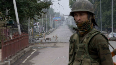 An Indian soldier guards a deserted road  during lockdown in Srinagar, Indian controlled Kashmir, on Thursday.
