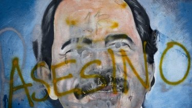 The Spanish word for 'murderer' covers a mural of Nicaragua's President Daniel Ortega, as part of anti-government protests demanding his resignation in Managua, Nicaragua..