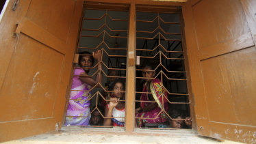 Villagers of Chandrabhaga fishing village take shelter at a government run school building after they were evacuated by the authorities in the Puri district of eastern Odisha state, India.