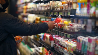 A shopper takes a product off a shelf at an Amazon Fresh cashierless convenience store.