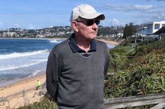 Eric Belzer, a Wamberal resident stands at the beach-side end of his home. The Central Coast Council approved his redevelopment plan only if he move his house closer to the sea than his existing one, he says.