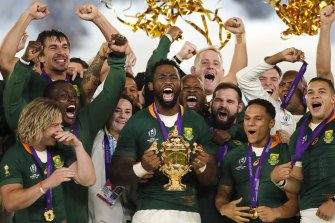 Siya Kolisi lifts the Rugby World Cup trophy after victory in 2019.