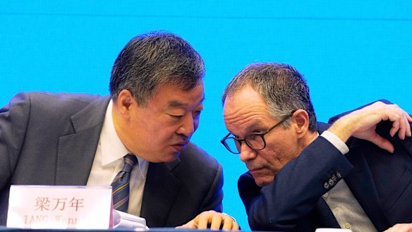 Peter Ben Embarek, of the World Health Organization team, right, chats with his Chinese counterpart Liang Wannian during a WHO-China Joint Study Press Conference held at the end of the WHO mission in Wuhan on Tuesday.