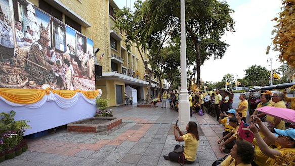 Thai people watch the ceremony on television.