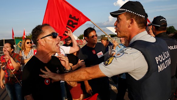 Police attempt to defuse tensions between supporters of jailed former president Lula and President Jair Bolsonaro as both groups keep vigil outside the Supreme Court in Brasilia on Thursday.