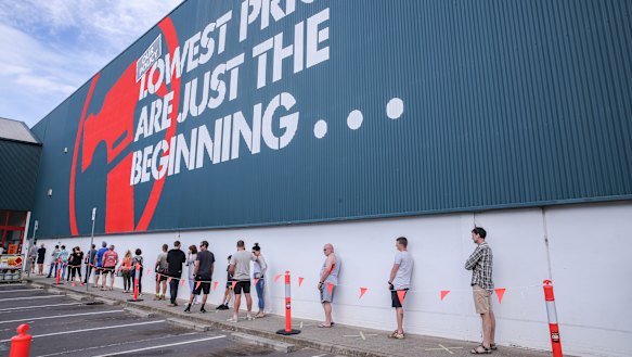 Shoppers practice social distancing outside a Bunnings store in Croydon on Sunday.