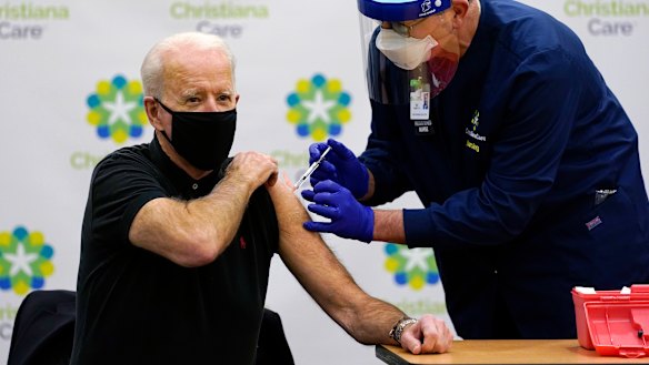 Focused: President-elect Joe Biden receives his second dose of the coronavirus vaccine from Chief Nurse Executive Ric Cuming in Newark on Monday.