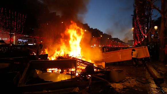 Demonstrators set up a burning barricade on the Champs-Elysees avenue during a demonstration against the rising of the fuel taxes on Saturday.