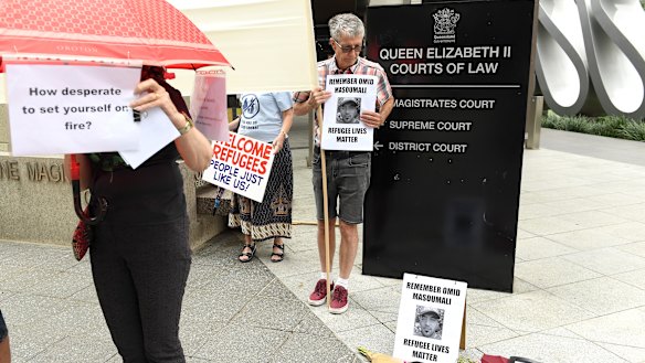 Supporters outside the inquest into Omid Masoumali's death in Brisbane on Monday.