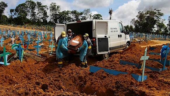 Cemetery workers carry the remains of 89-year-old Abilio Ribeiro, who died of COVID-19, in Manaus, Amazonas state.