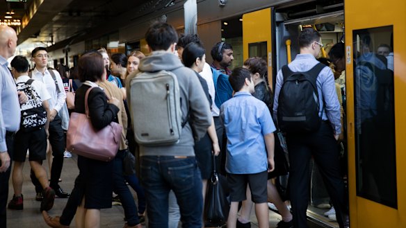 Passengers board a train at Chatswood station this week.
