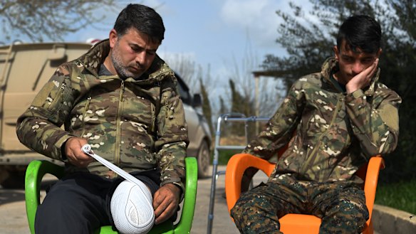 Sipan Abdulrahman Khadir (left) who lost the lower part of his left leg in Baghouz reapplies the bandage to his leg as Sipan Ezzo, 20, looks on. Ezzo lost both legs and his right hand and part of his arm.