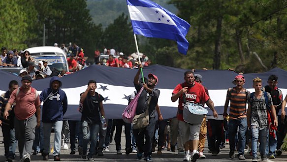 Hondurans march in a caravan of migrants moving toward the country's border with Guatemala. 