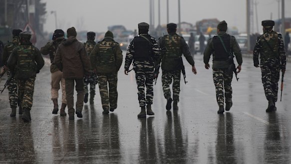 Indian paramilitary soldiers patrol near the site of an explosion in Pampore, Indian-controlled Kashmir.