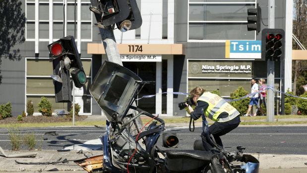 Police inspect the remnants of the BMW.