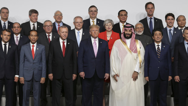 Spot the women ... leaders posing for the G20 'family photo'. Theresa May makes it into this frame.
