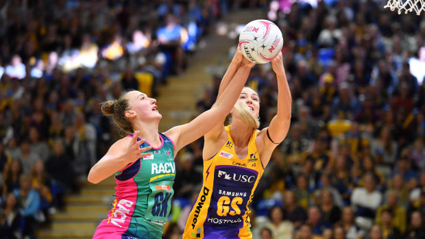 Committed: Lightning's Caitlin Bassett and Vixens' Emily Mannix battle in their last clash.