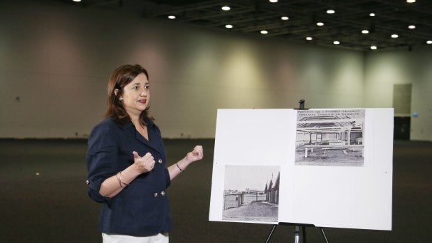 Premier Annastacia Palaszczuk  in one of the Royal International Convention centre's spaces which could be converted into makeshift hospitals, next to images of the RNA being used as a field hospital during the 1919 Spanish flu epidemic in Brisbane.