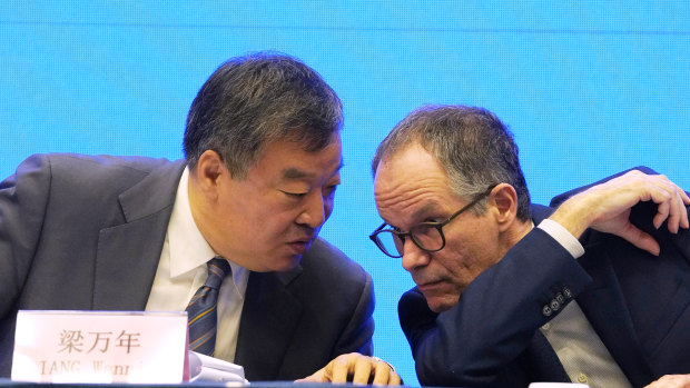 Peter Ben Embarek, of the World Health Organization team, right, chats with his Chinese counterpart Liang Wannian during a WHO-China Joint Study Press Conference held at the end of the WHO mission in Wuhan on Tuesday.