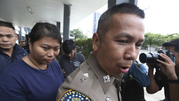 The  is led by police to a court after her arrest in Bangkok.