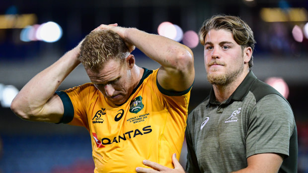 Fraser McReight (right) comforts Reece Hodge after a Wallabies match in 2020.