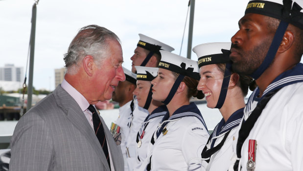 Prince Charles speaks with Able Seaman Jessica Gross (second from right) on board the HMAS Leeuwin at the HMAS Cairns navy base.