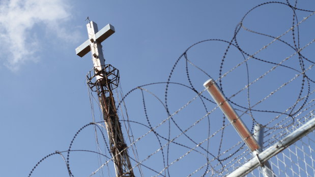 A steel cross rises above the border fence at the Demilitarised Zone seperating North and South Korea.