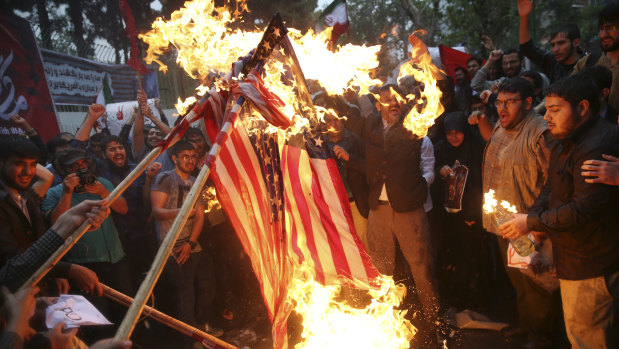 Hardline Iranian demonstrators burn US flags during a gathering in front of the former US Embassy in Tehran.