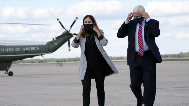 Vice-President Mike Pence and his wife Karen prepare to address the media as they leave Washington for Utah, where the vice-presidential debate will take place.
