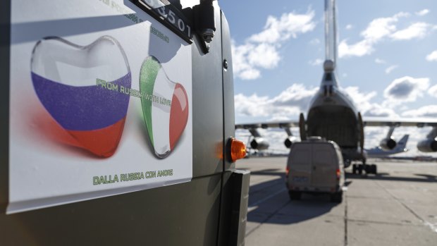 Military trucks load onto an Il-76 cargo plane at Chkalovsky military airport outside Moscow, Russia. 