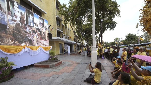 Thai people watch the ceremony on television.