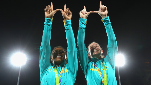 Ellia Green (left) and Chloe Dalton make the Warringah "W" after the medal ceremony at the Rio Olympics.