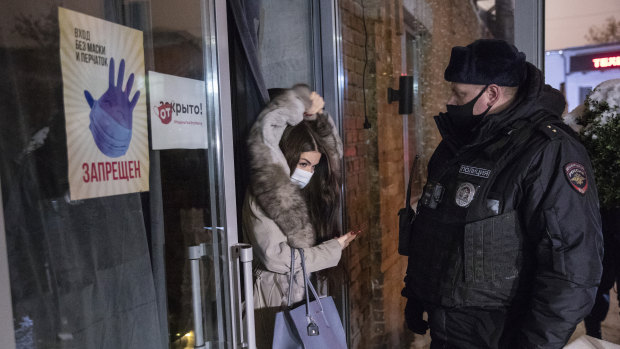 A woman leaves a bar during a police raid in Moscow. 