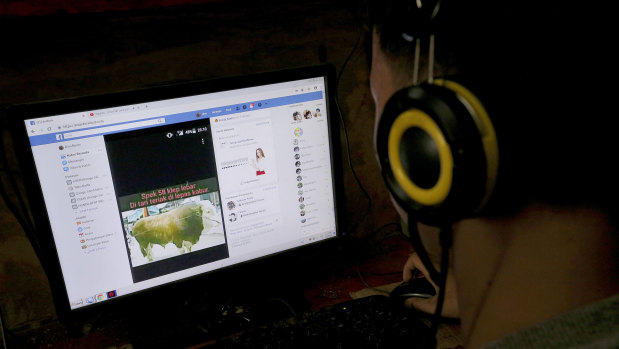 An Indonesian youth browses his Facebook page at an Internet cafe in Jakarta.