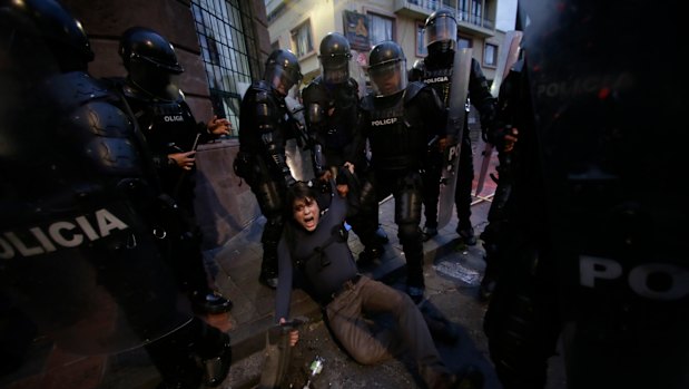 A man is detained by police blocking protesters from advancing closer to the presidential palace in Quito, Ecuador, last week.