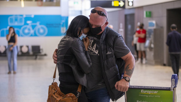 A passenger is greeted by a loved one after arriving on NZ123.