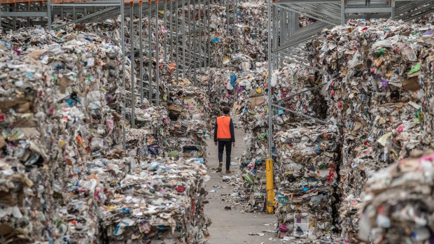 A warehouse stacked to the rafters with bales of recycling waste.