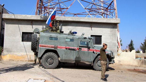Russian forces armored vehicles patrol the Syrian border in Kobani.